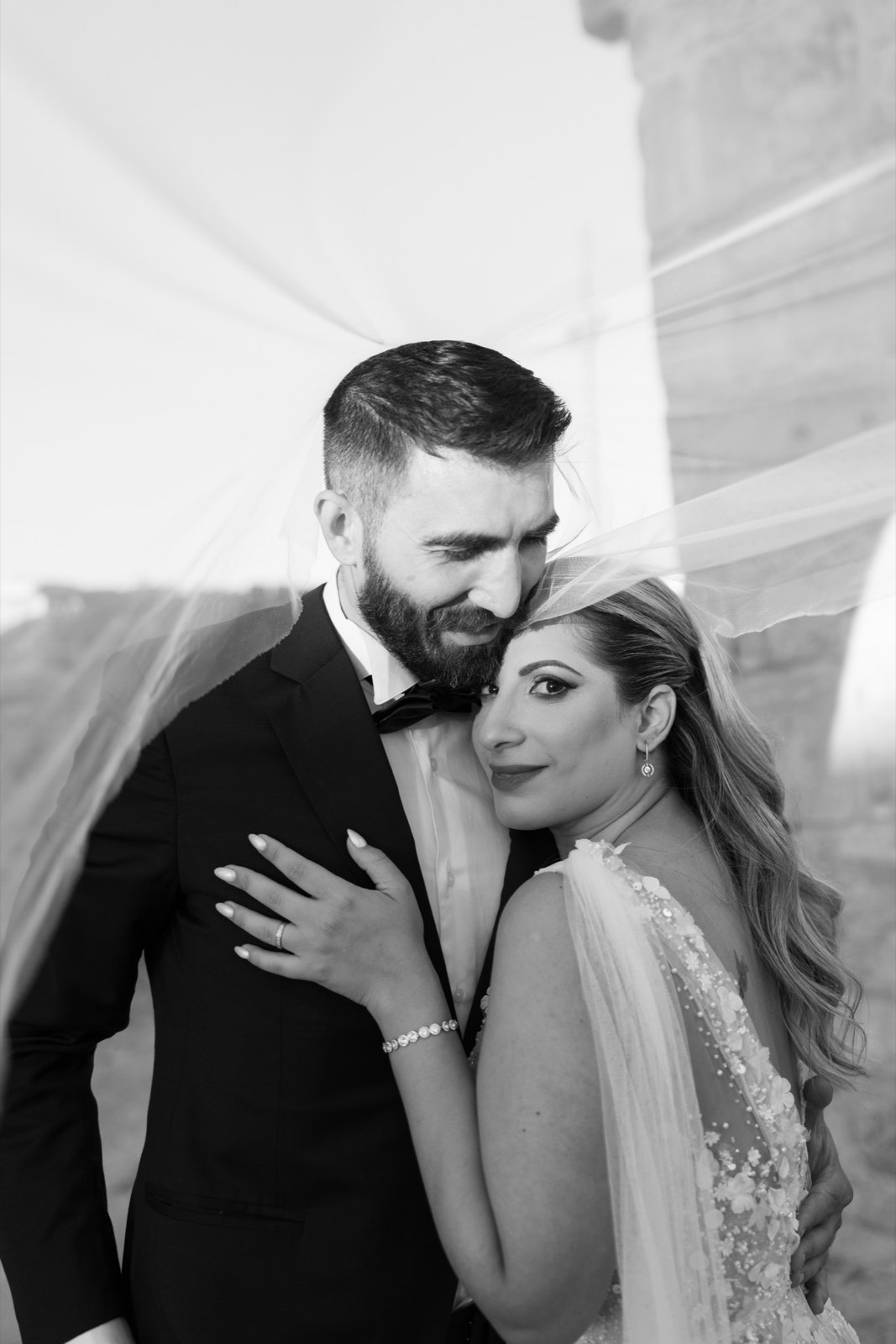 Close wedding portrait of Giorgos and Andriana beneath the bridal veil