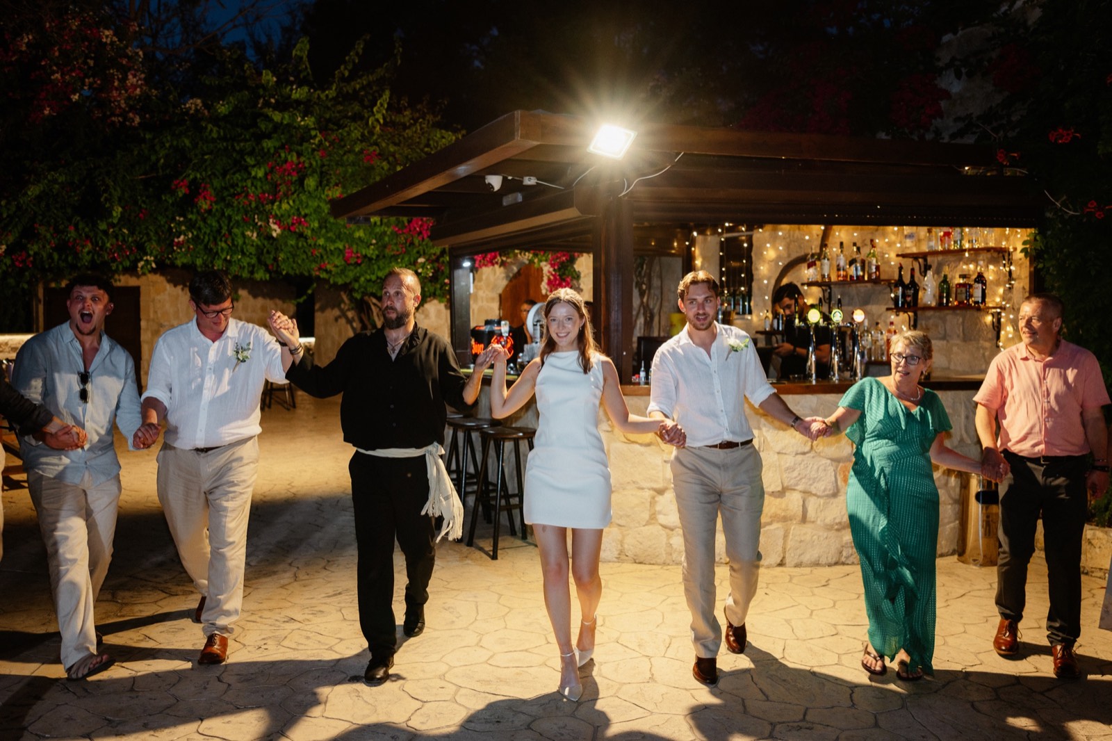 Harriet and Tom leading their guests in an evening wedding dance